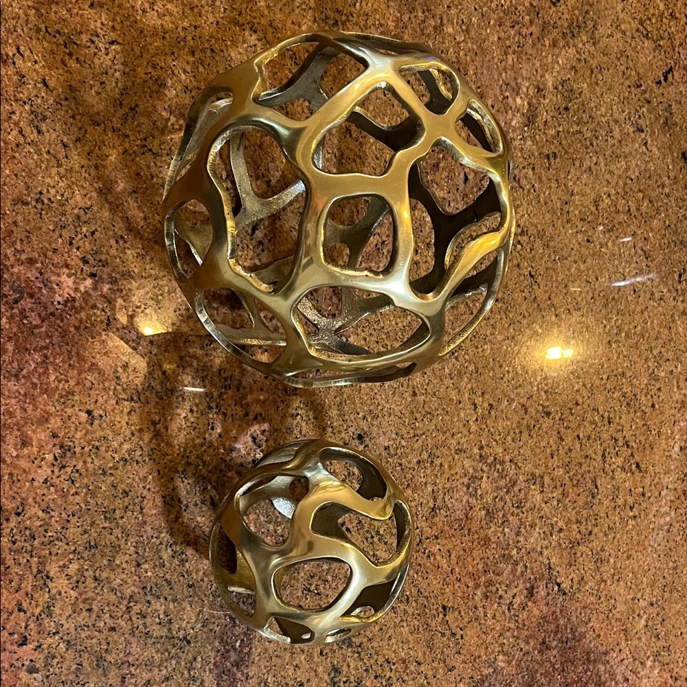 2 brass colored ball decorations